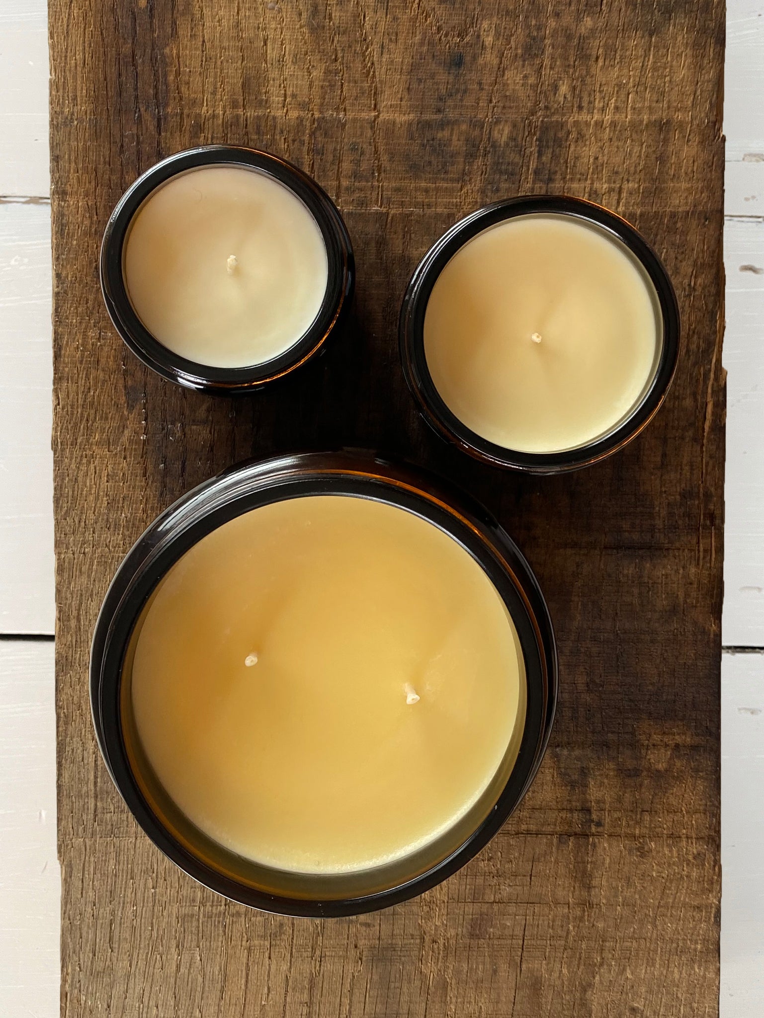 Three natural soy wax Bouclé candles in their different sizes 120ml 180ml & 500ml double wick. Each scented with essential oils  & poured in amber glass jars.