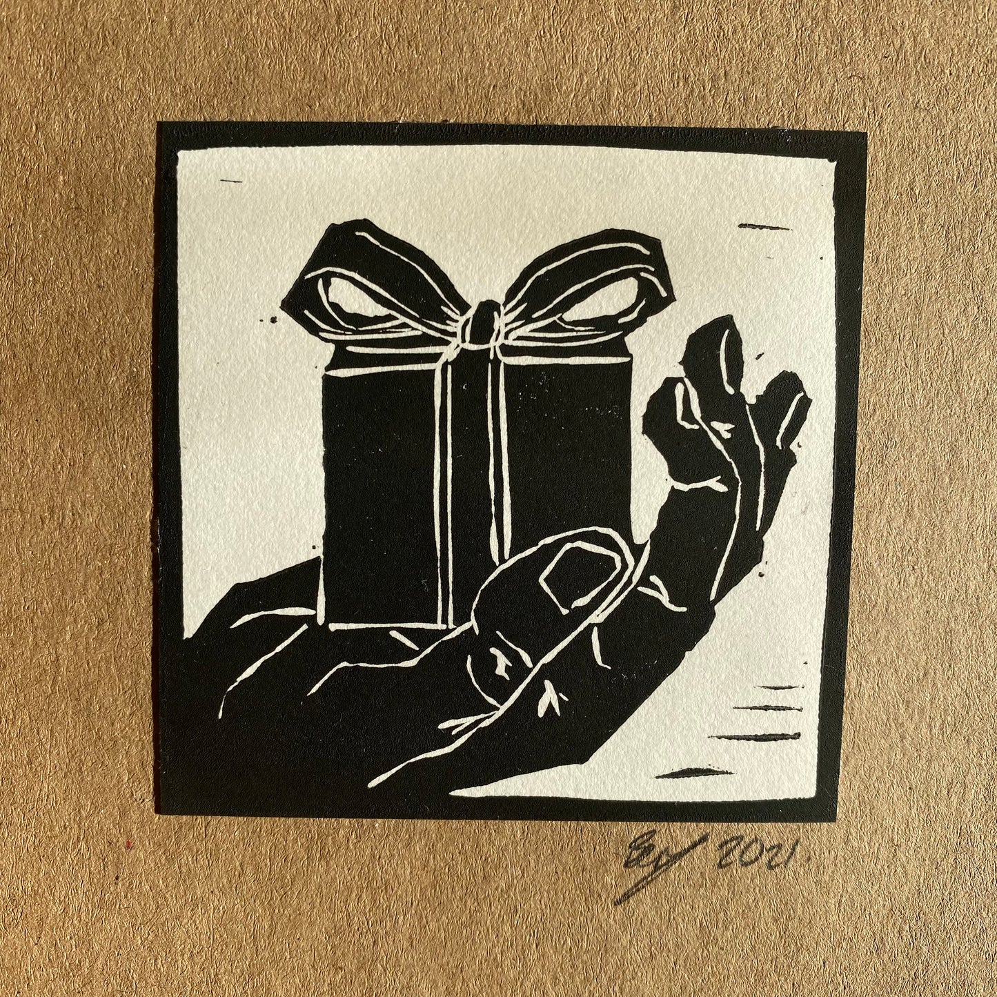 Gift in Hand hand printed greetings card design perfect for birthdays or Christmas