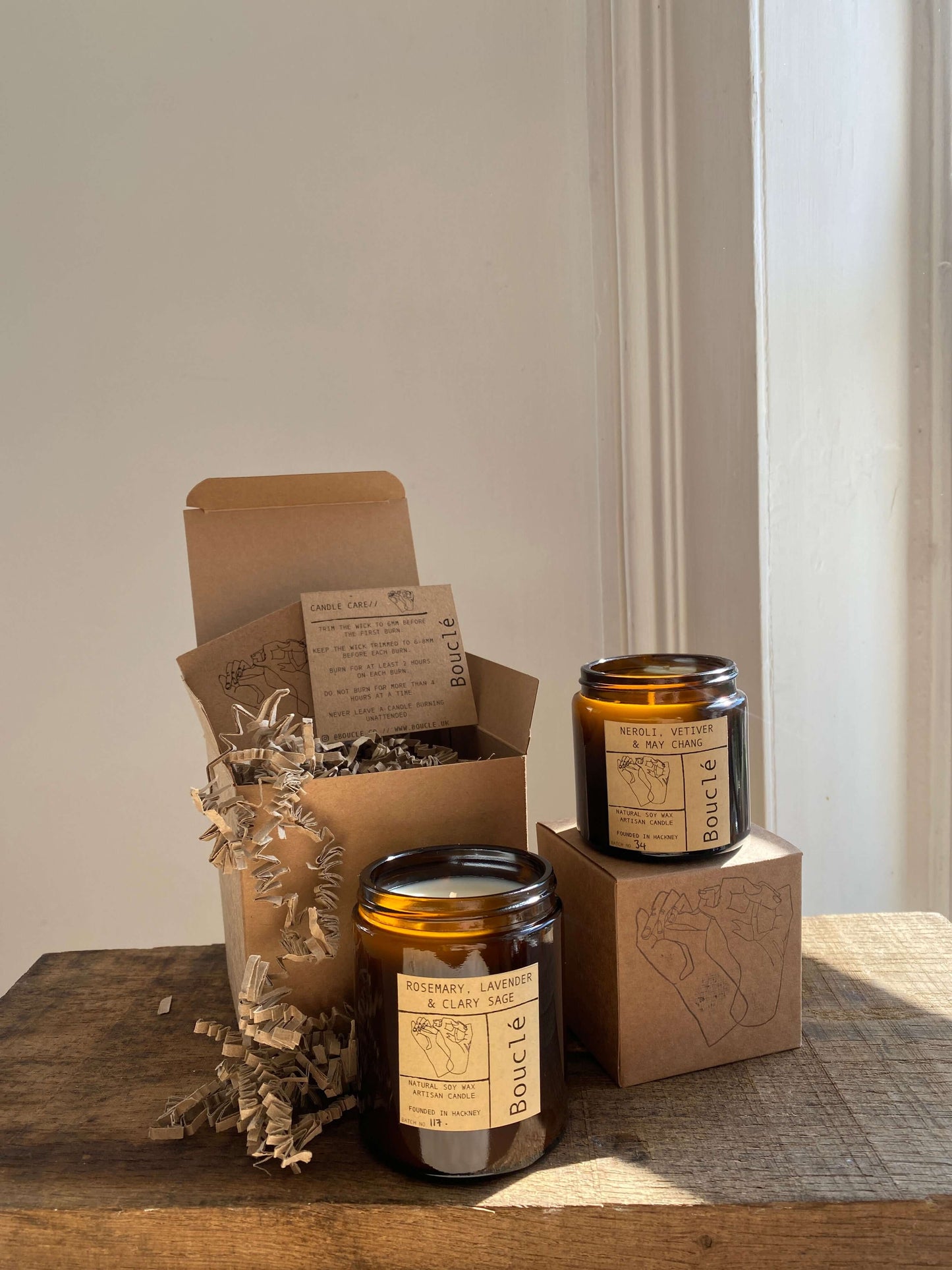 Bouclé natural flower London candles in recycled kraft gift boxes filled with krinkle cut card.