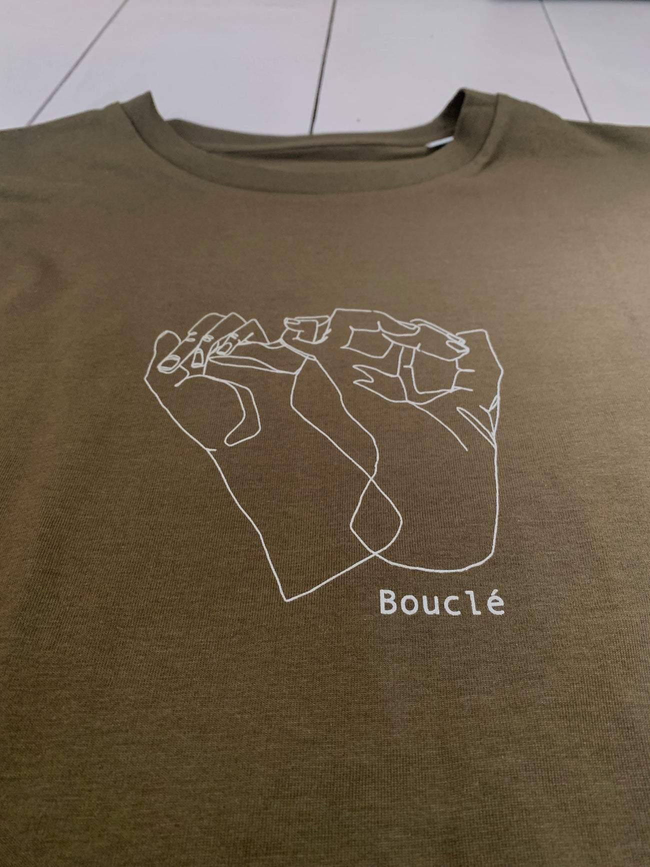 Off-white logo line illustration print on olive green long sleeve t-shirt which was designed in Hackney