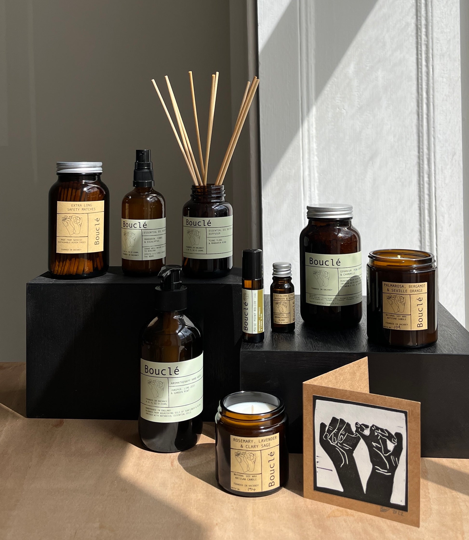 Collection of Bouclé all-natural candles and scented room sprays on display.