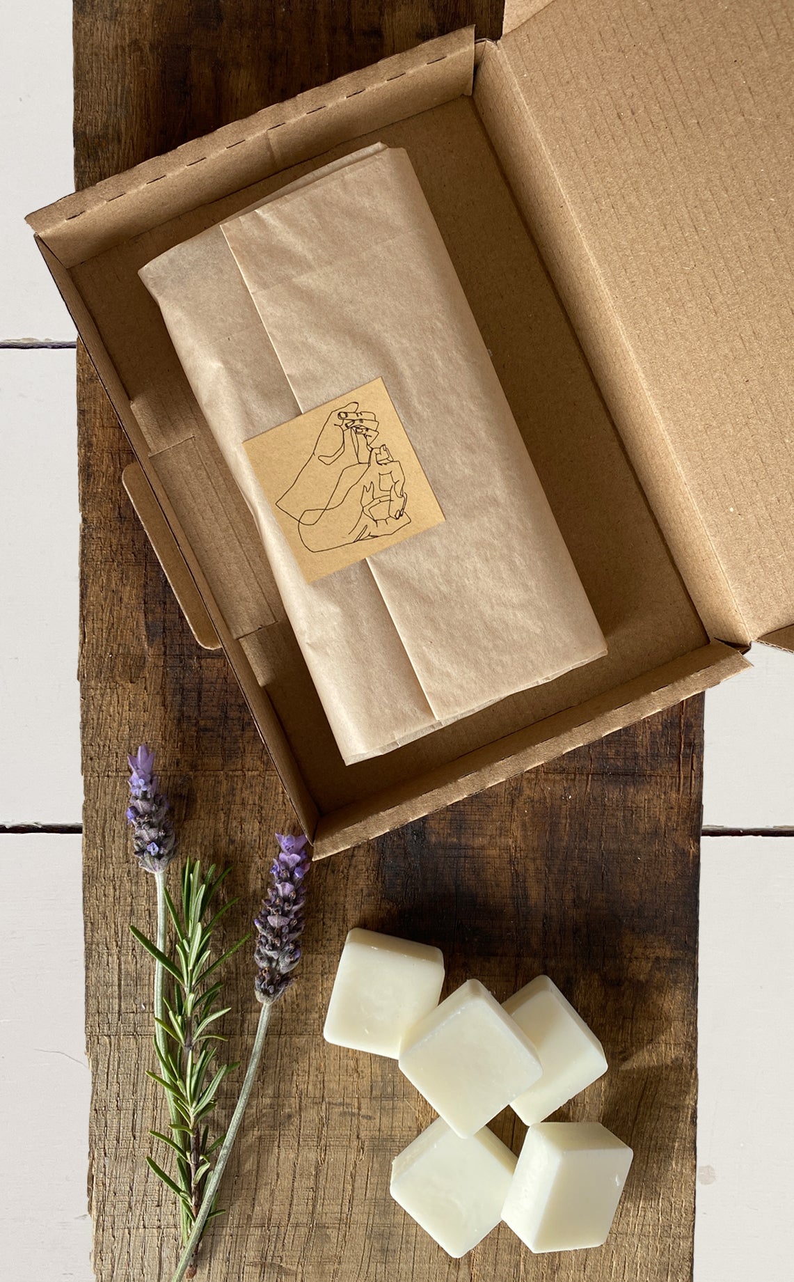 The wax melts are completely natural and packaged plastic free in tissue and a hand stamped box. Alongside them are the natural ingredients rosemary and lavender.