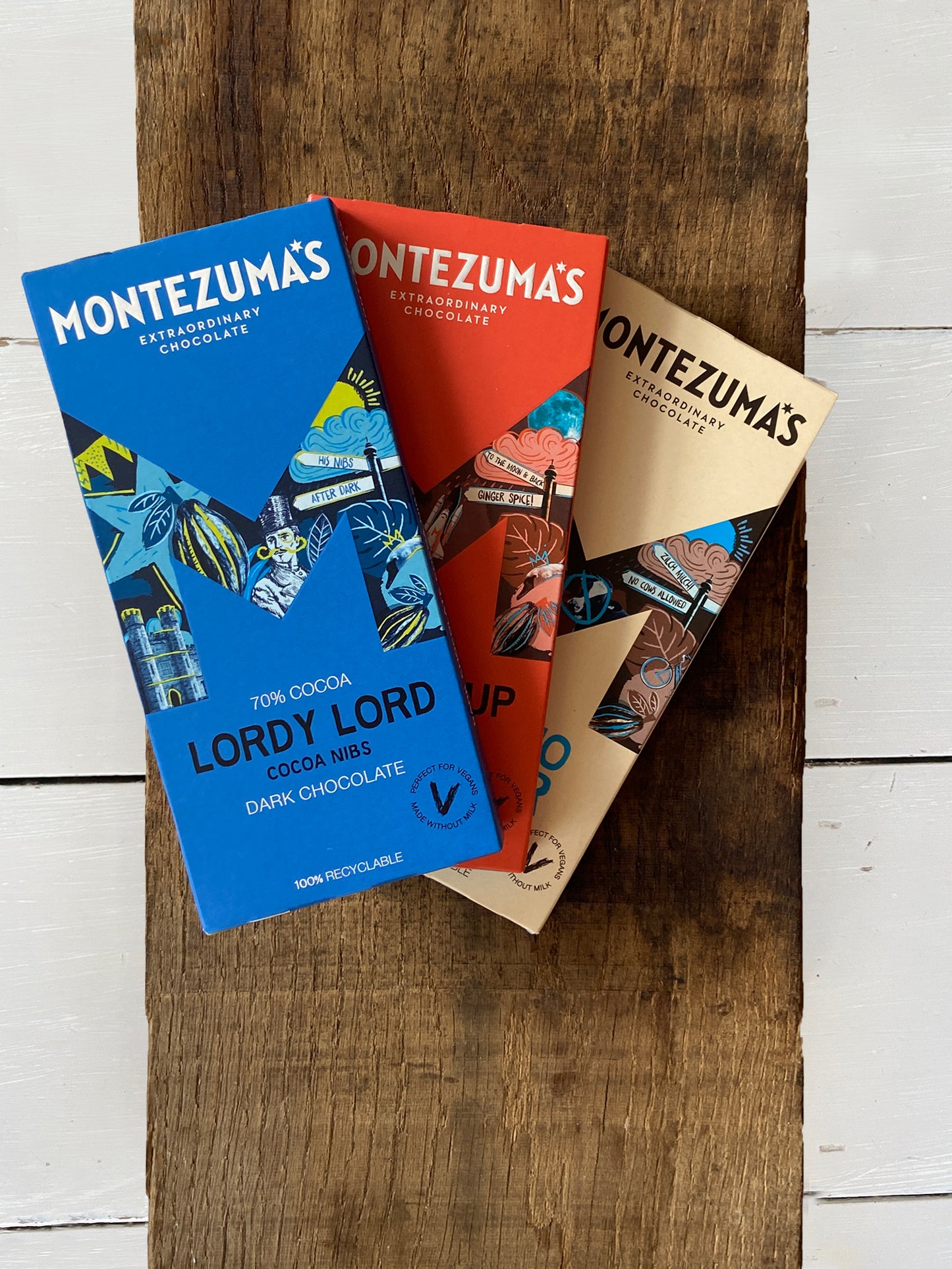 Montezuma's vegan organic chocolate bar selection including lordy lord dark chocolate nibs, dark chocolate and ginger, and like no udder milk chocolate alternative.