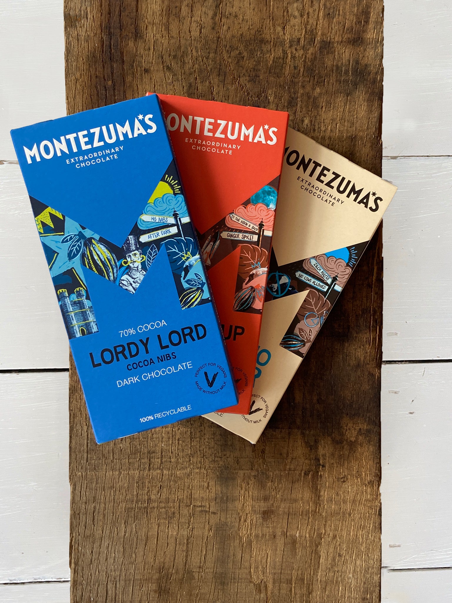 Montezuma's vegan organic chocolate bar selection including lordy lord dark chocolate nibs, dark chocolate and ginger, and like no udder milk chocolate alternative.