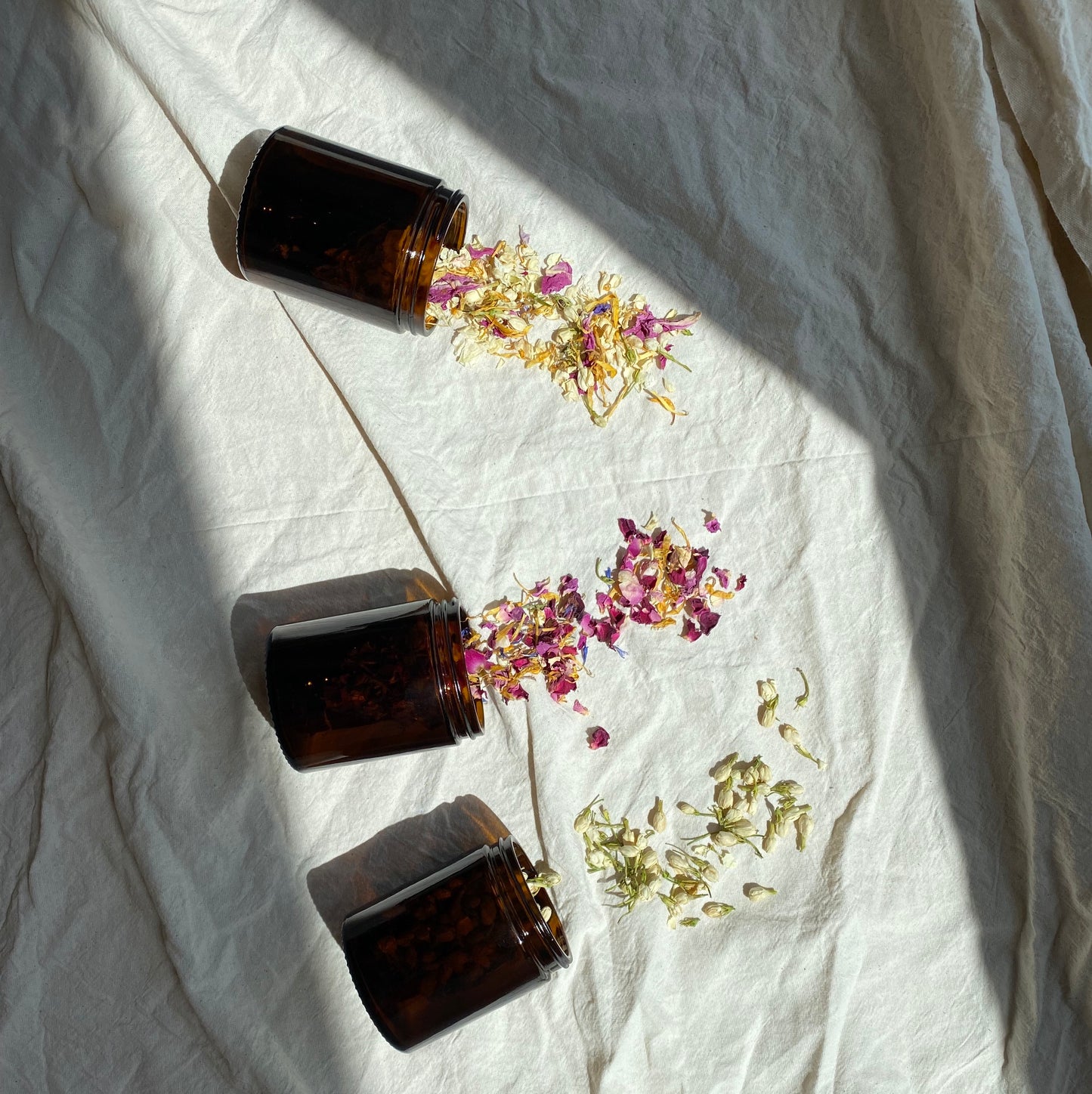 The three unique confetti blends pouring out of amber glass jars. Perfect for eco-friend weddings and eco brides.