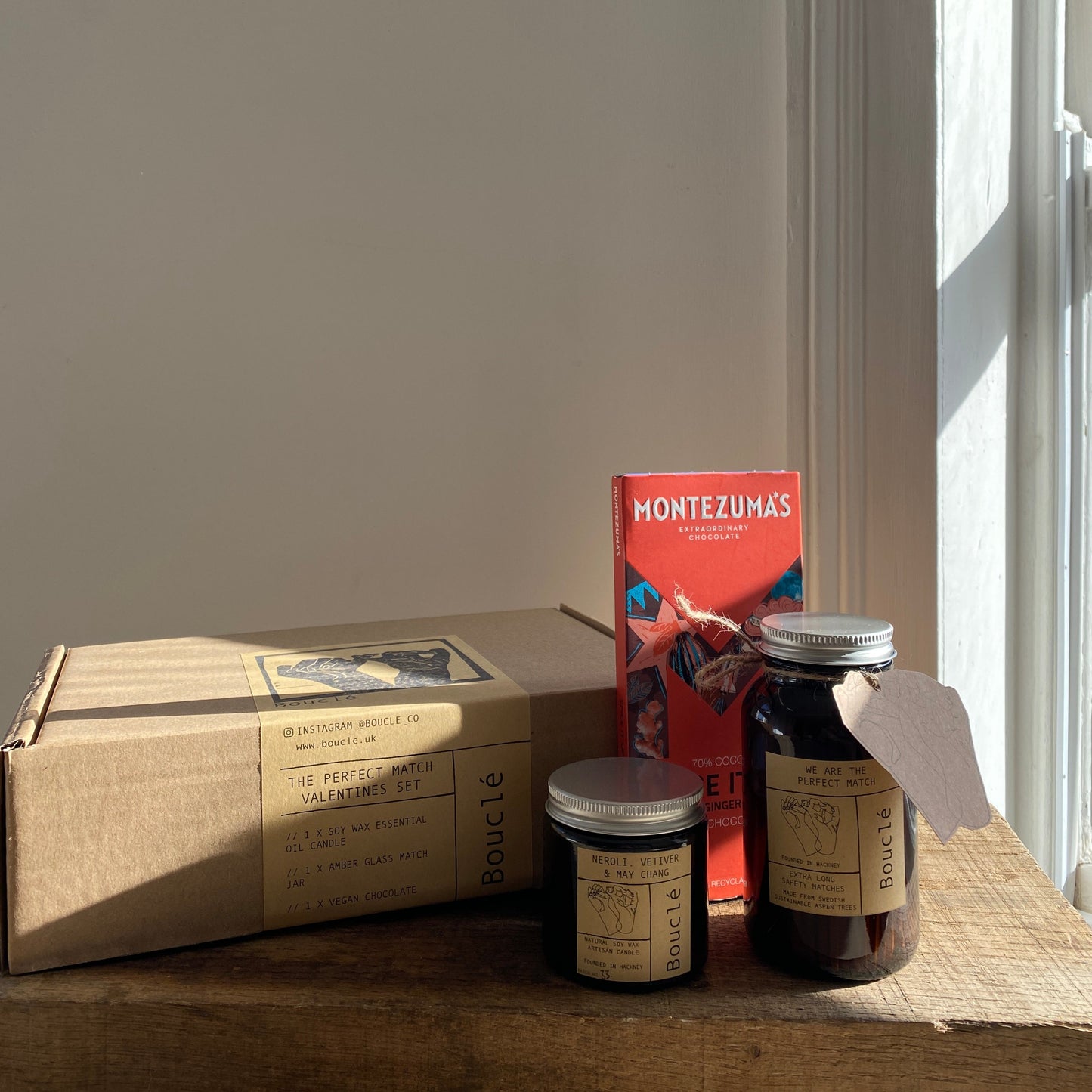 The vegan natural flower candle, jar of extra long safety matches & chocolate will come presented in a recycled gift box sealed with a Bouclé London label.