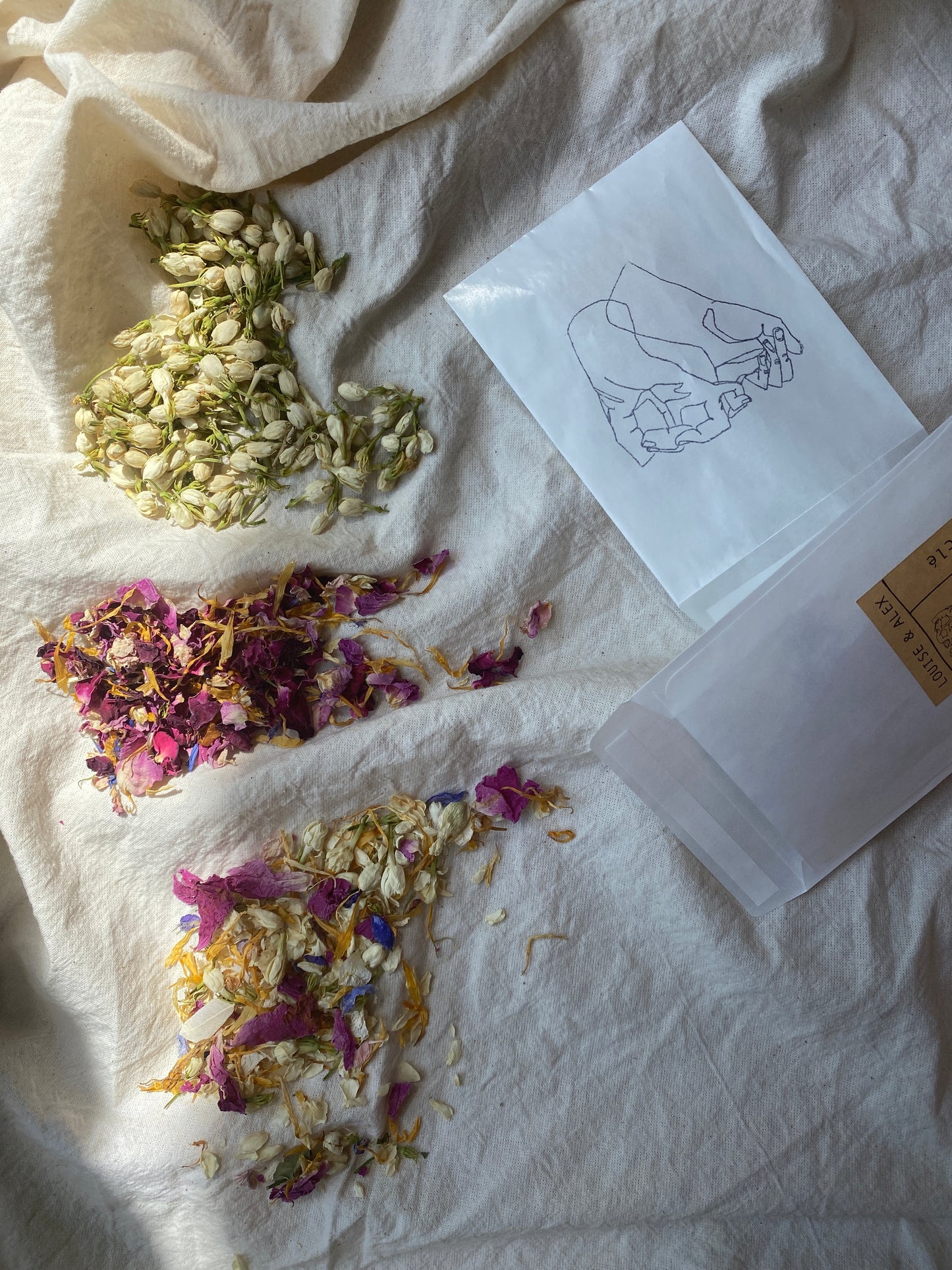 Three varieties of dried flower petal confetti for wedding styling. There is a vibrant multi coloured, a muted rose blush and cream colour-way or a monochrome white jasmine bud. In personalised glassine pouches.