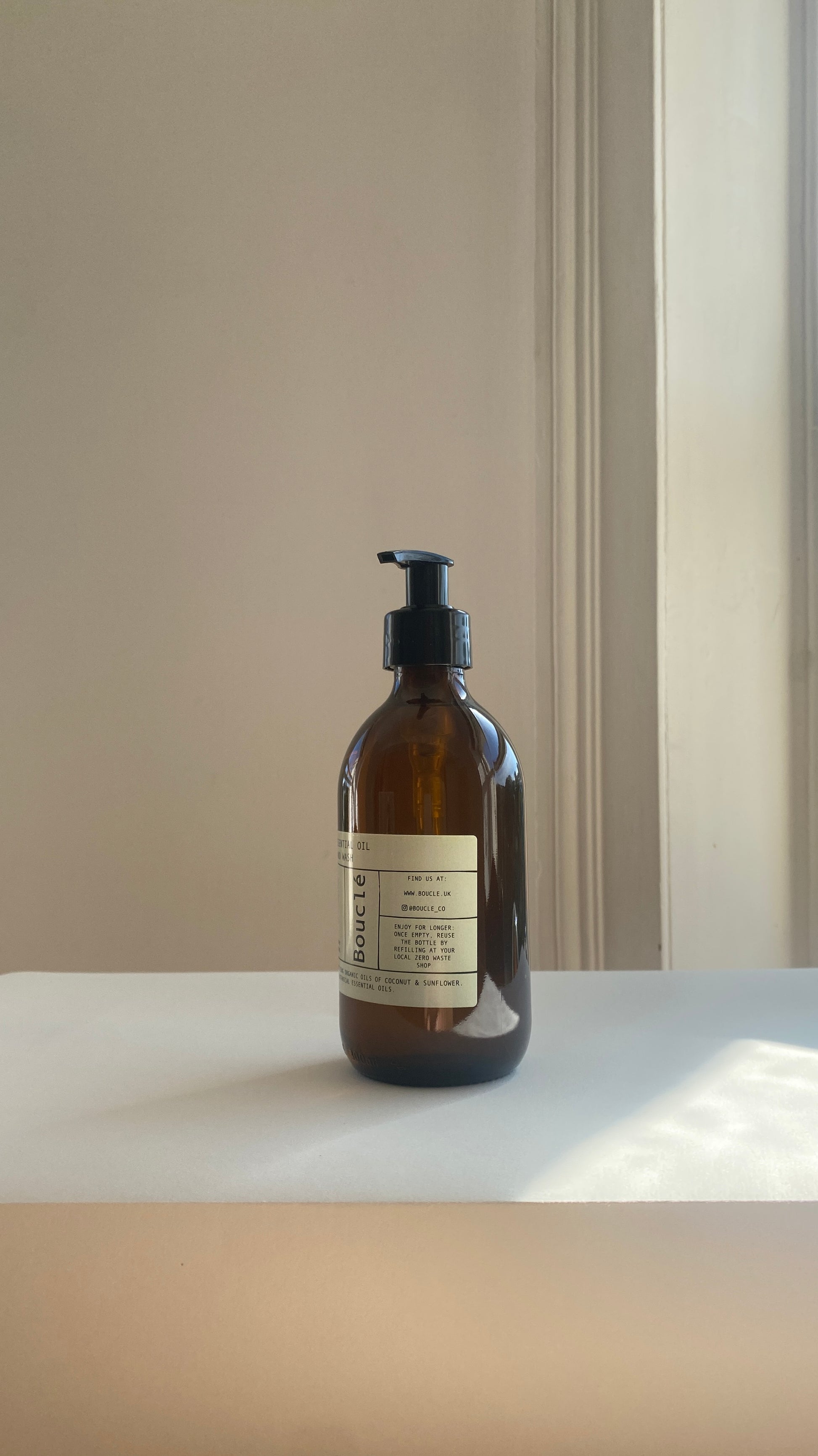 Apothecary style amber glass bottle of vegan natural handwash by Bouclé founded in Hackney in East London. Made with botanical organic ingredients for sensitive skin.