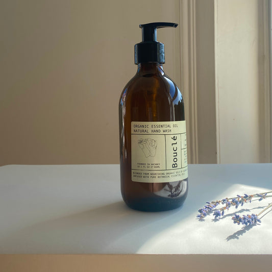 Hackney organic natural hand wash made with essential oils and vegetable oils. Amber soap bottle next to lavender sprigs