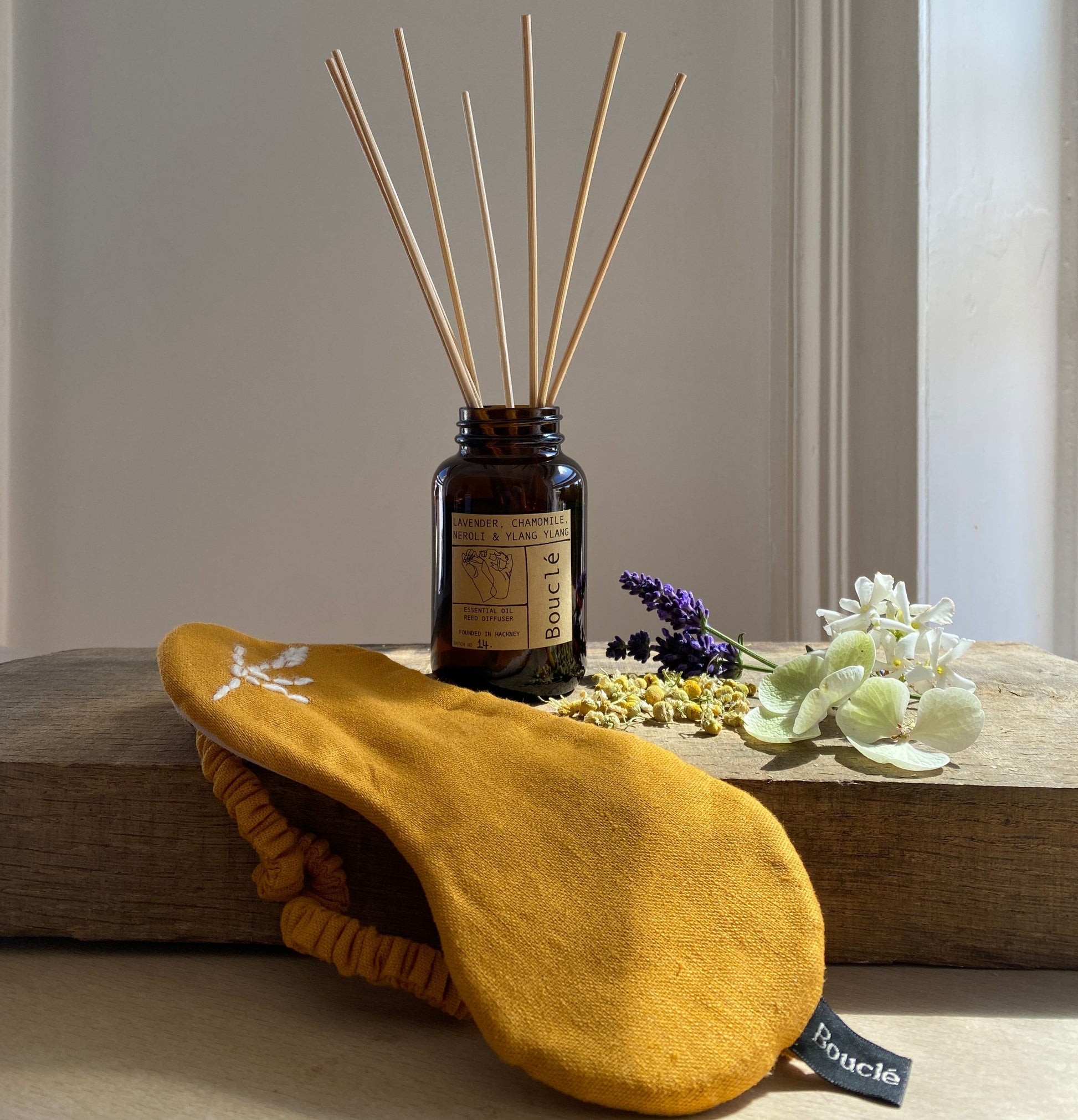 Natural ingredients alongside the floral calming reed diffuser and hand embroidered eye mask.