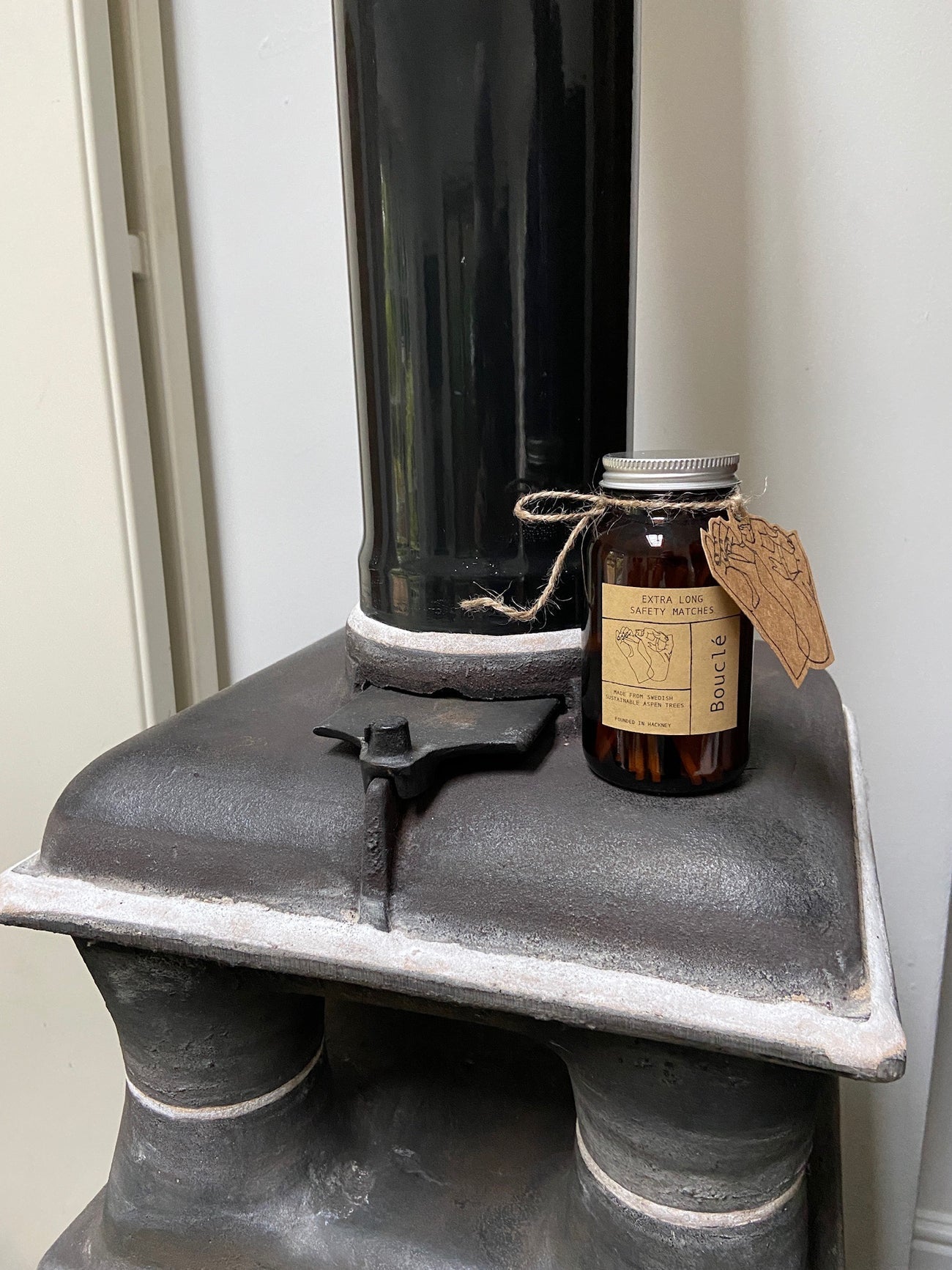 Bouclé amber glass match jar with aluminium lid and hand stamped gift tag is filled with extra long safety matches. Hand made in East London & Brighton