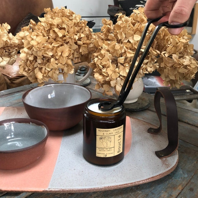 Bouclé wick trimmer trimming a natural soy wax rosemary, lavender & clary sage candle wick